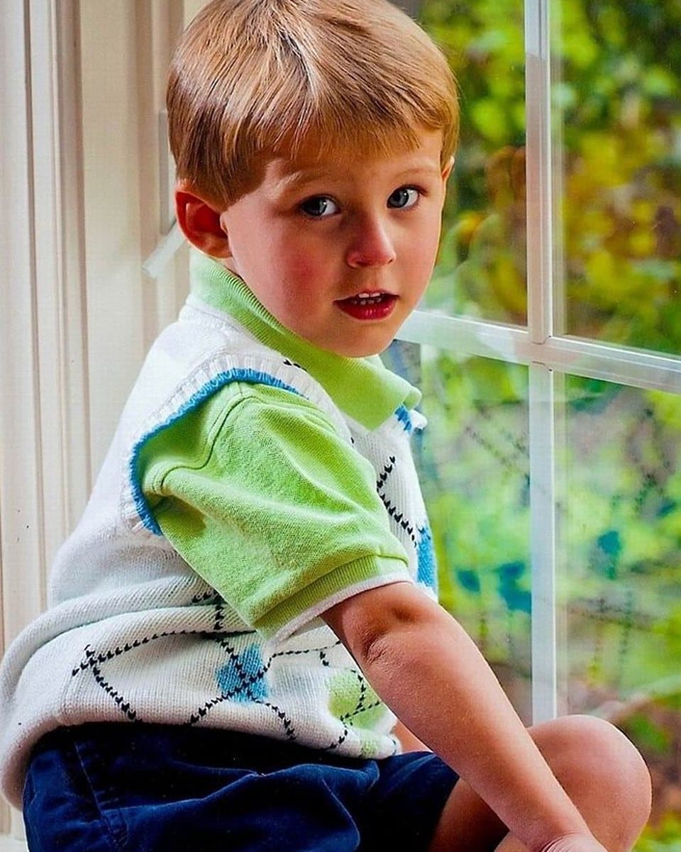The photograph of a young boy sitting by a window that the painting was made from