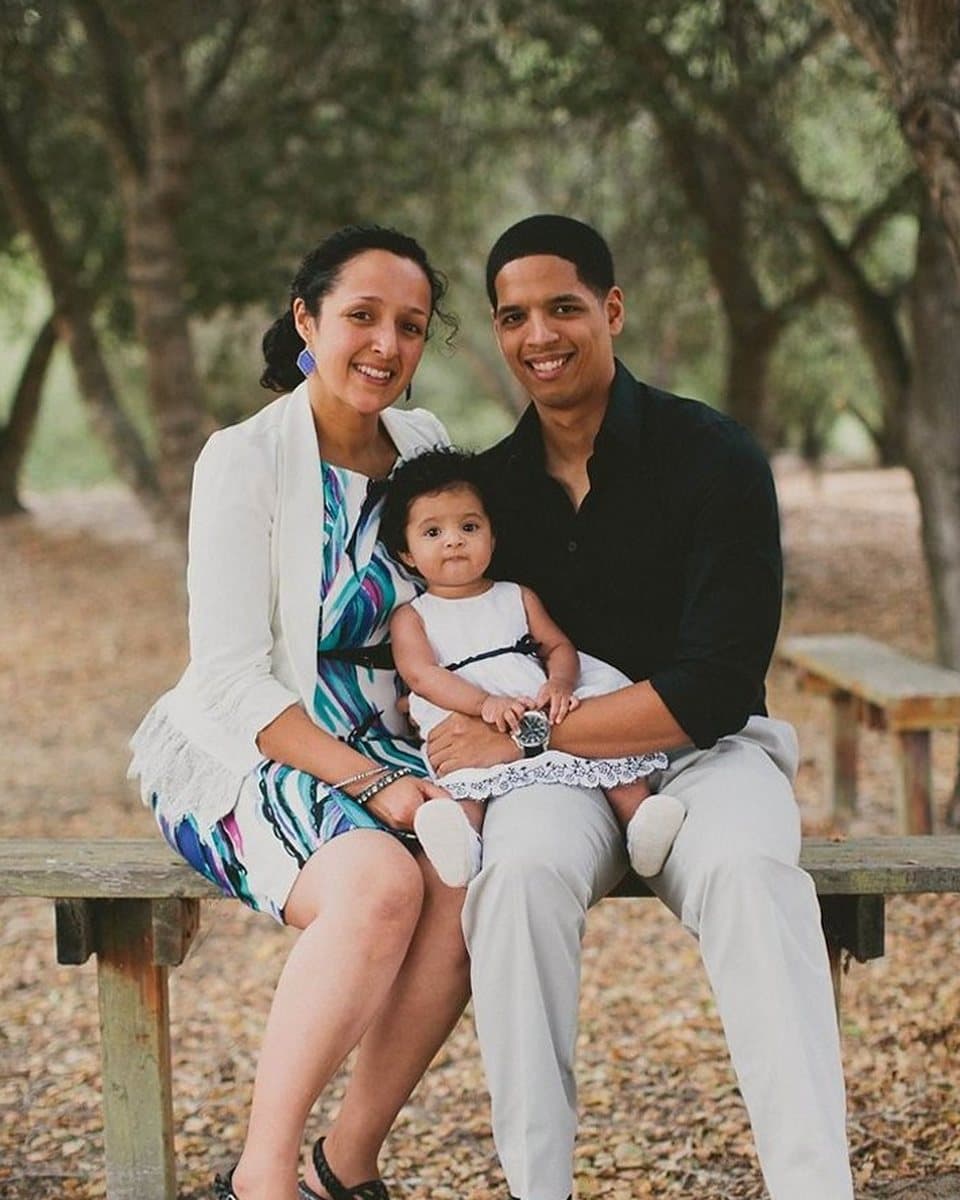 The photograph of a mother, father and baby on a bench that the painting was made from