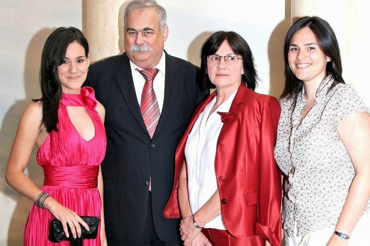 The photograph of a family of four standing together that the painting was made from