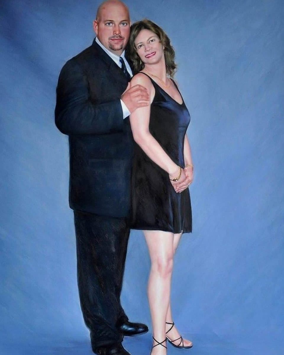 Oil painting of a couple against a plain blue backdrop